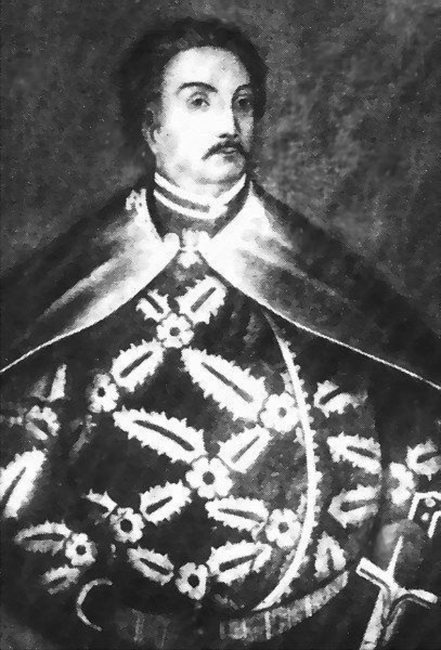 Schwarzes und weißes Foto von Papst Johannes Paul II. in Priesterrobe, trägt eine schwarze Robe mit weißem Kragen und Manschetten, Hände gefaltet, strenger Ausdruck, direkter Blick.