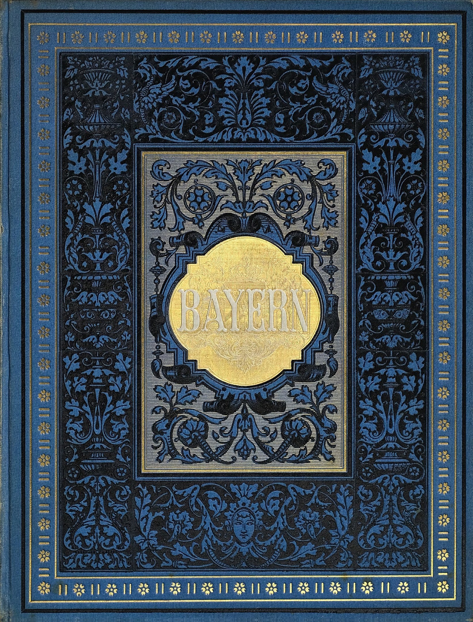 Blau-goldenes Buch mit dem Wort "Bayern" auf dem Cover, das mit detaillierten Verzierungen versehen ist.