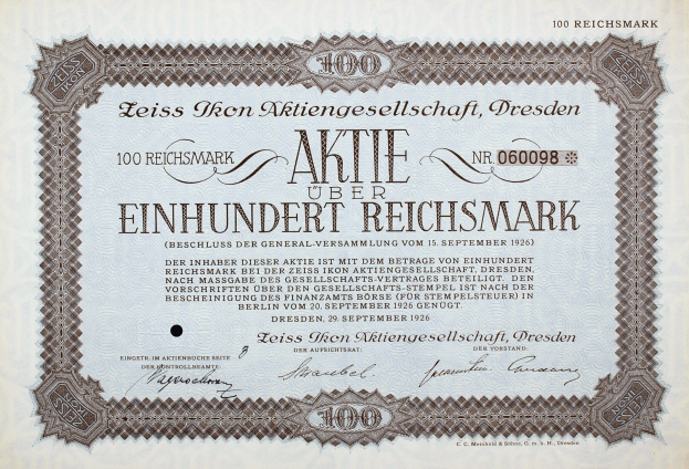 Altes deutsches Aktienzertifikat über 100 Reichsmark mit schwarzem Rand und deutschem Text.